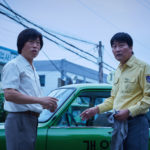 A destra uno sbalordito Kang-ho Song in un momento di A Taxi Driver di Hoon Jang (Taeksi Woonjunsa, Corea del Sud, 2017)